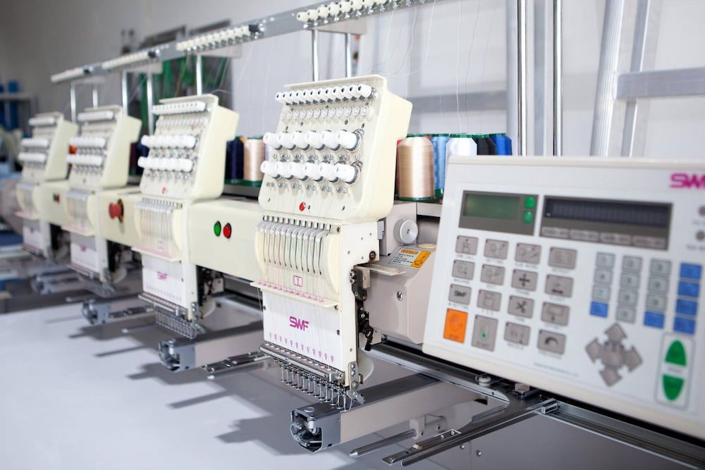 Row of Industrial Embroidery Machines in a Workshop — Workwise Clothing Forster in Wingham, NSW