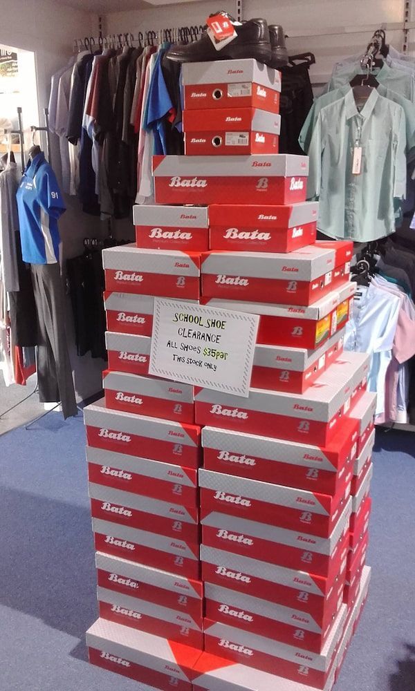 Display of Red and White Bata Shoe Boxes Stacked in a Store — Workwise Clothing Forster in Forster, NSW