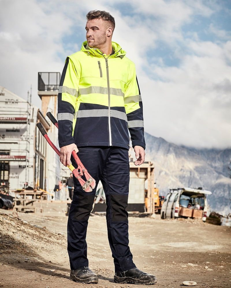 Man in Workwear, Holding Bolt Cutters at a Construction Site — Workwise Clothing Forster in Forster, NSW