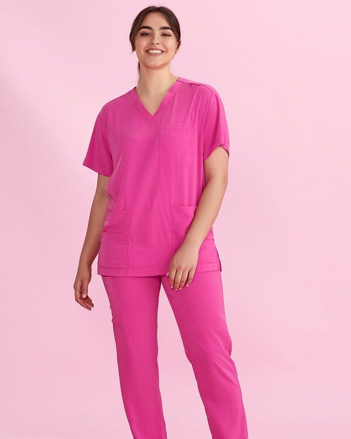 Woman in Pink, Smiling — Workwise Clothing Forster in Forster, NSW