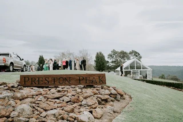 A group of people standing in front of a sign that says preston peak.