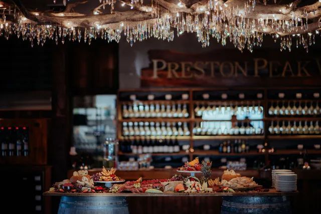 A bar filled with lots of food and wine bottles.