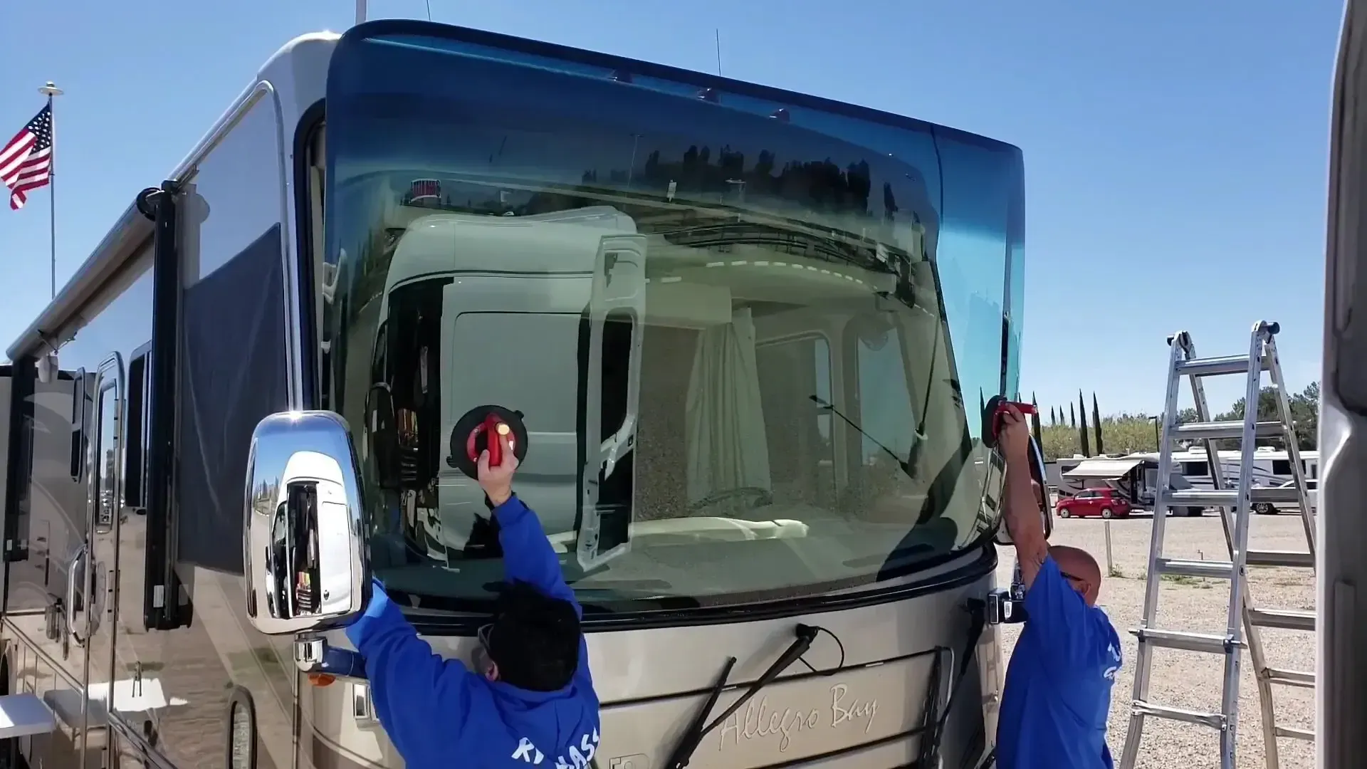 A man is installing a windshield on a rv