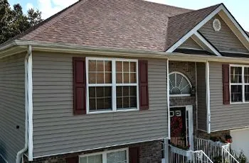a gutter on a roof with leaves on it