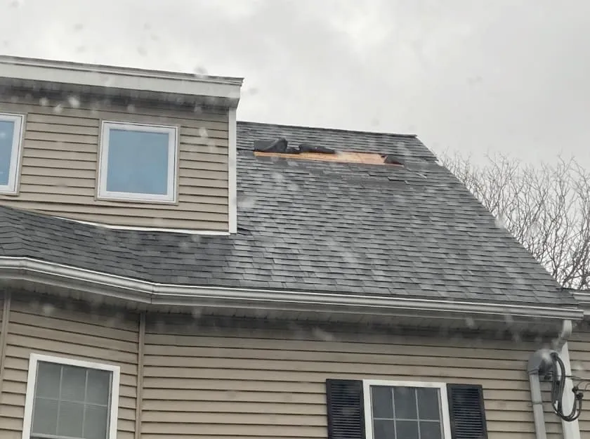 a brick house with a roof that is being installed