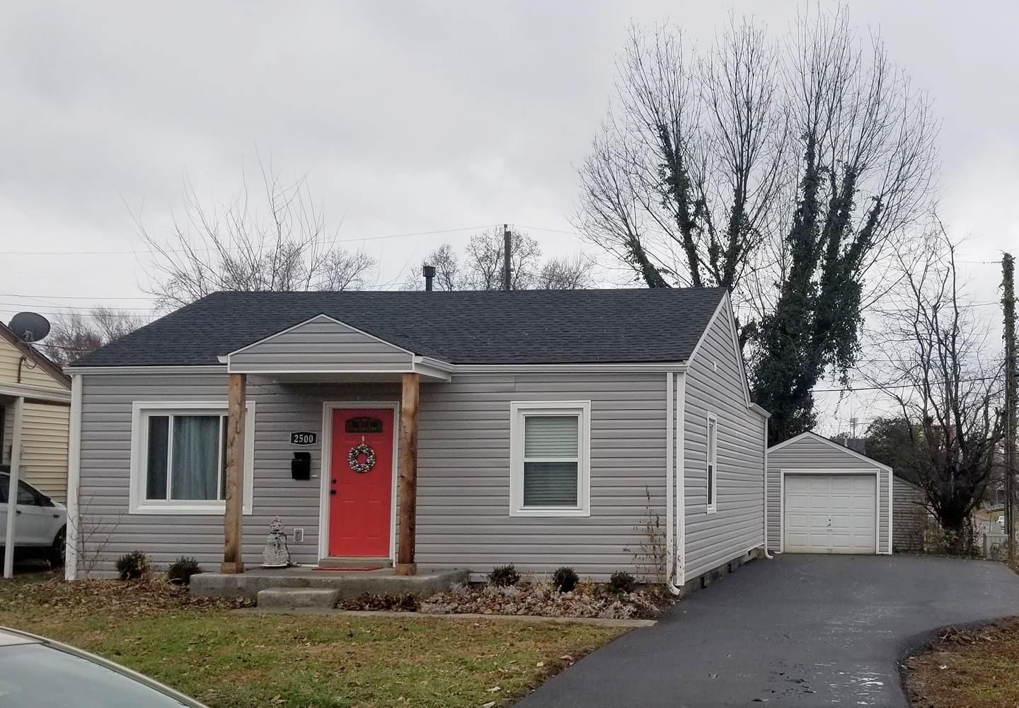 A small house with a red door and a garage