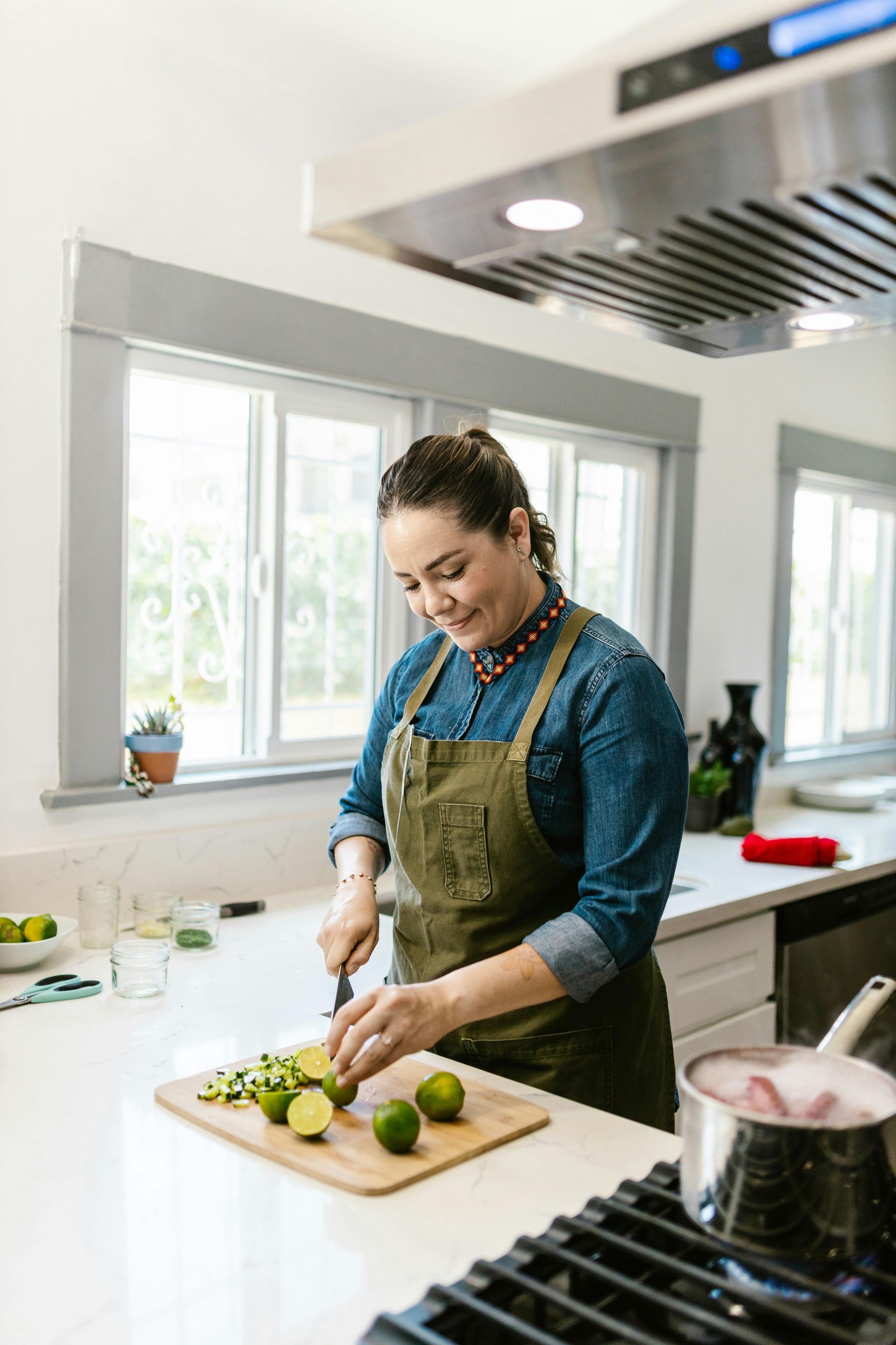A woman in her kitchen with window