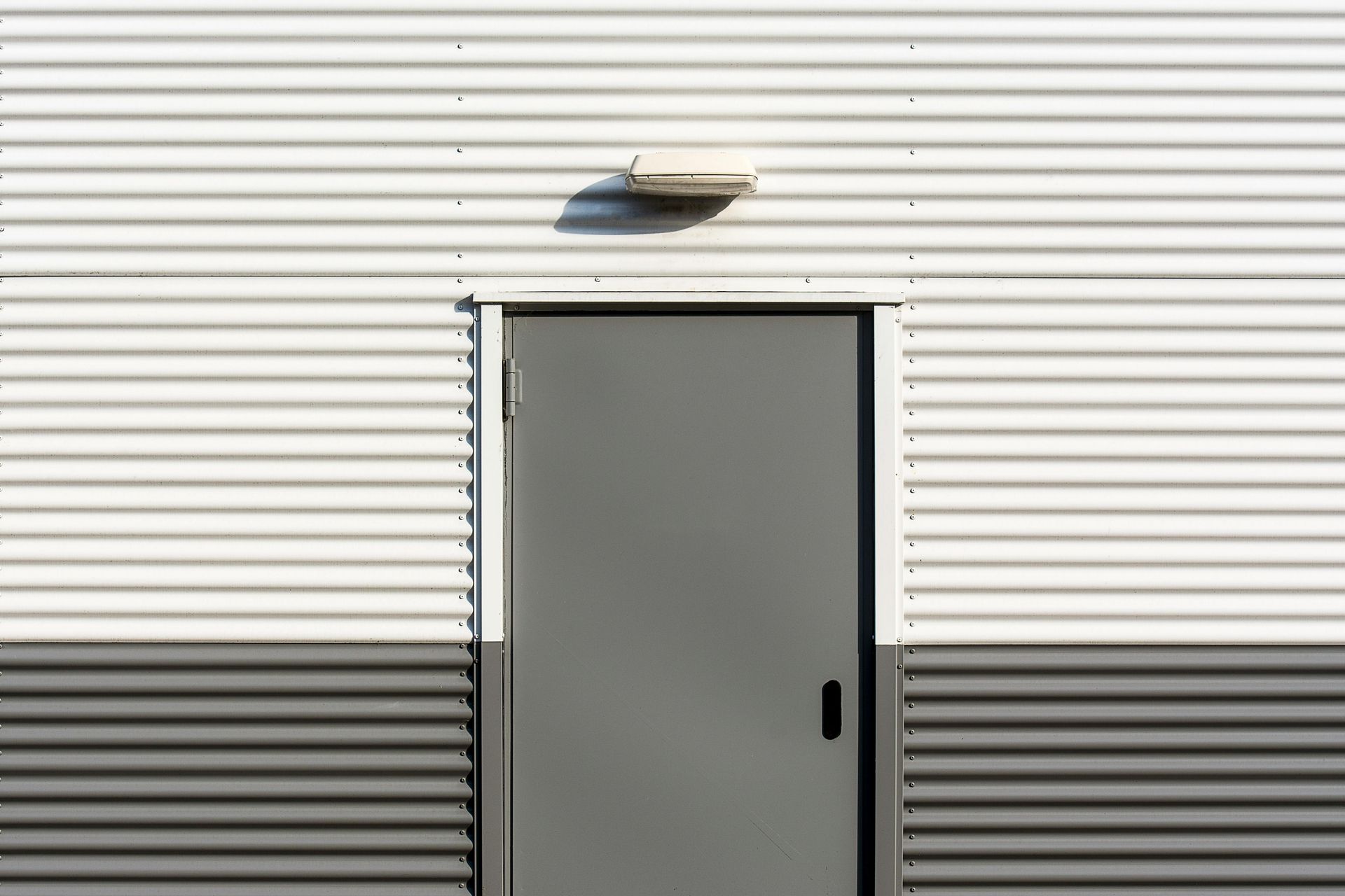 a house with white siding and a black roof