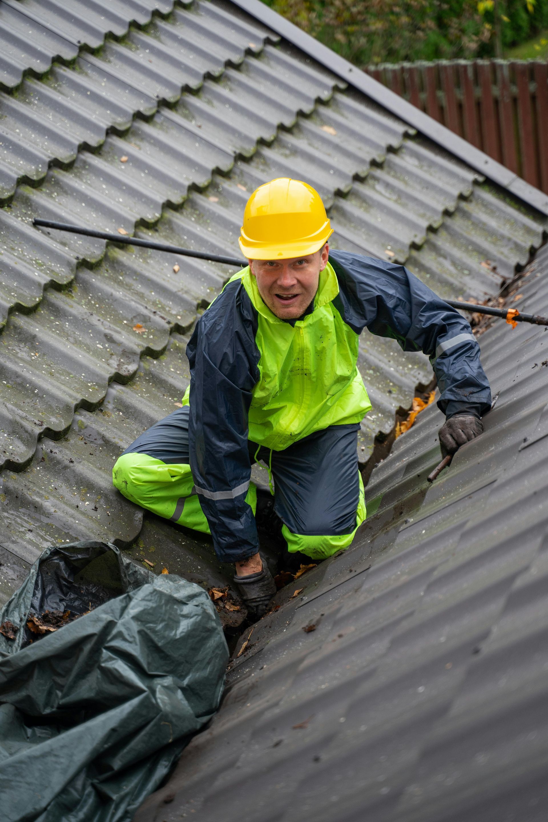 A man in her maintenance roof check