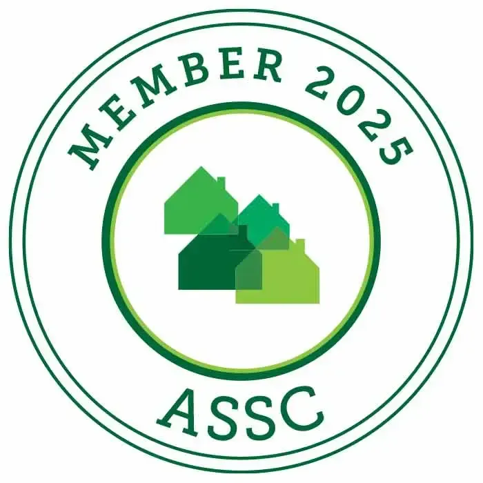 A green circle with houses in it that says member 2025 assc