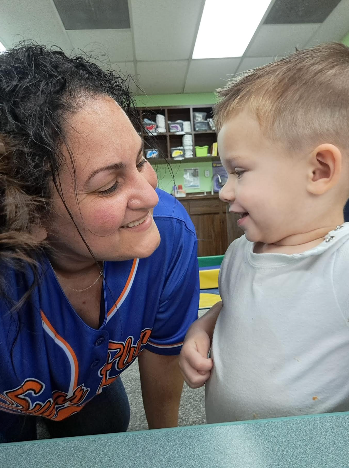 A woman wearing a blue jersey with the word tigers on it