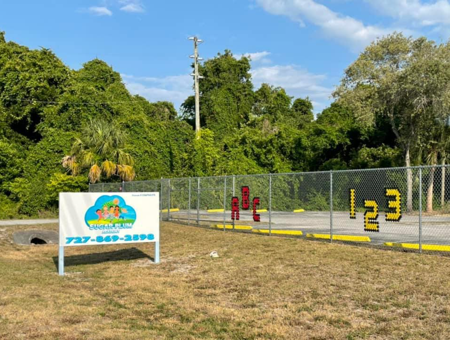 A fence with a sign that says 123 on it