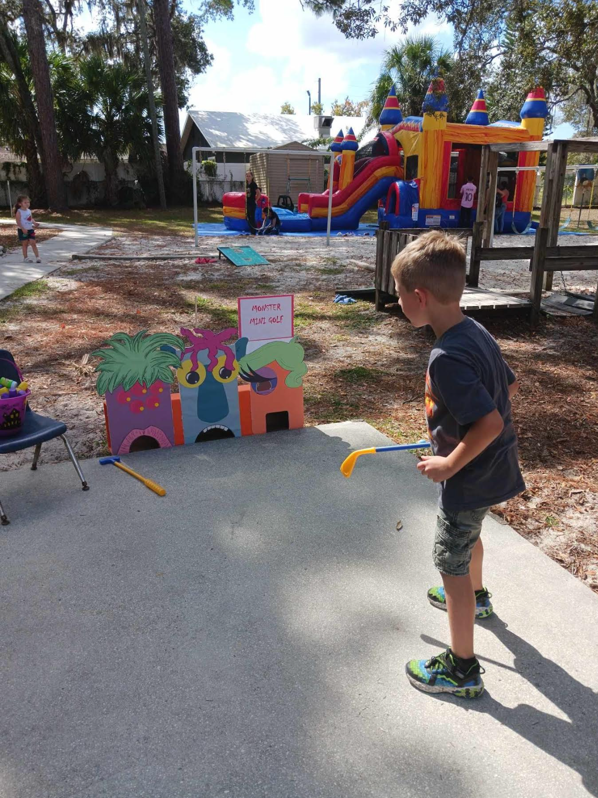 A young boy is playing a game of golf in a park