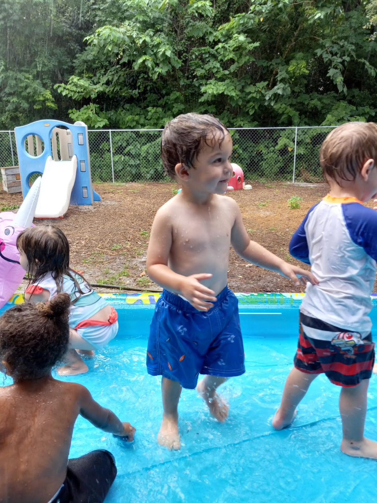 A group of children are playing in a pool.