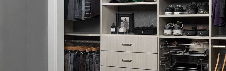 A closet filled with lots of clothes and shoes.