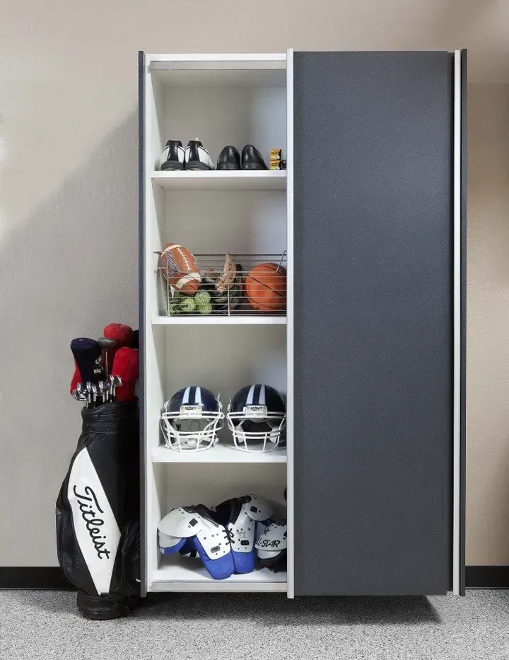 a tall garage cabinet with sports accessories.