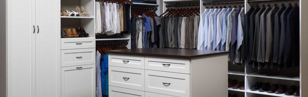 A walk in closet with a large island in the middle