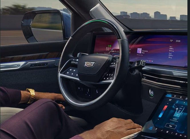 Interior of a luxury SUV with cream-colored quilted leather seats and a panoramic sunroof.