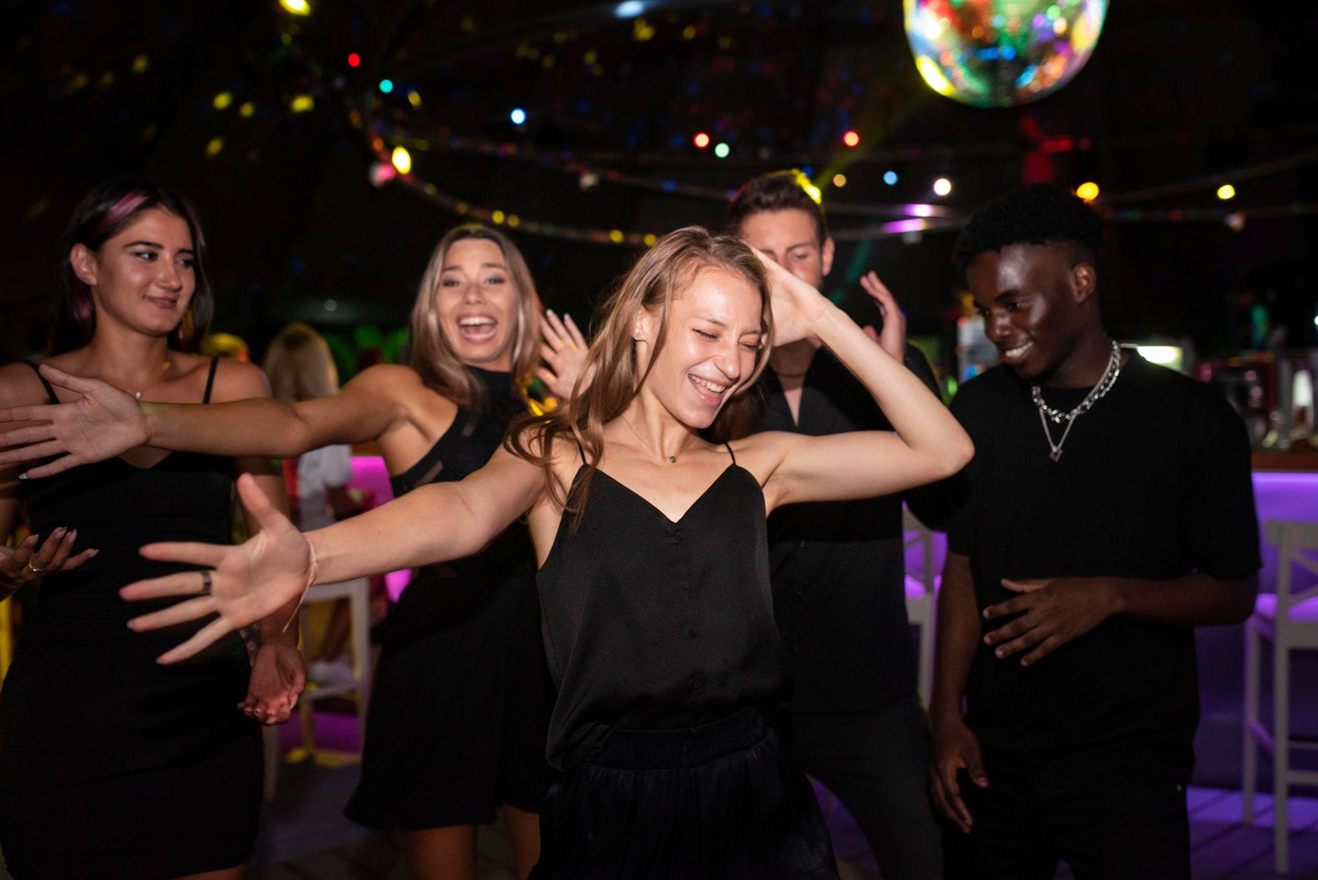 A group of people are dancing in a club.