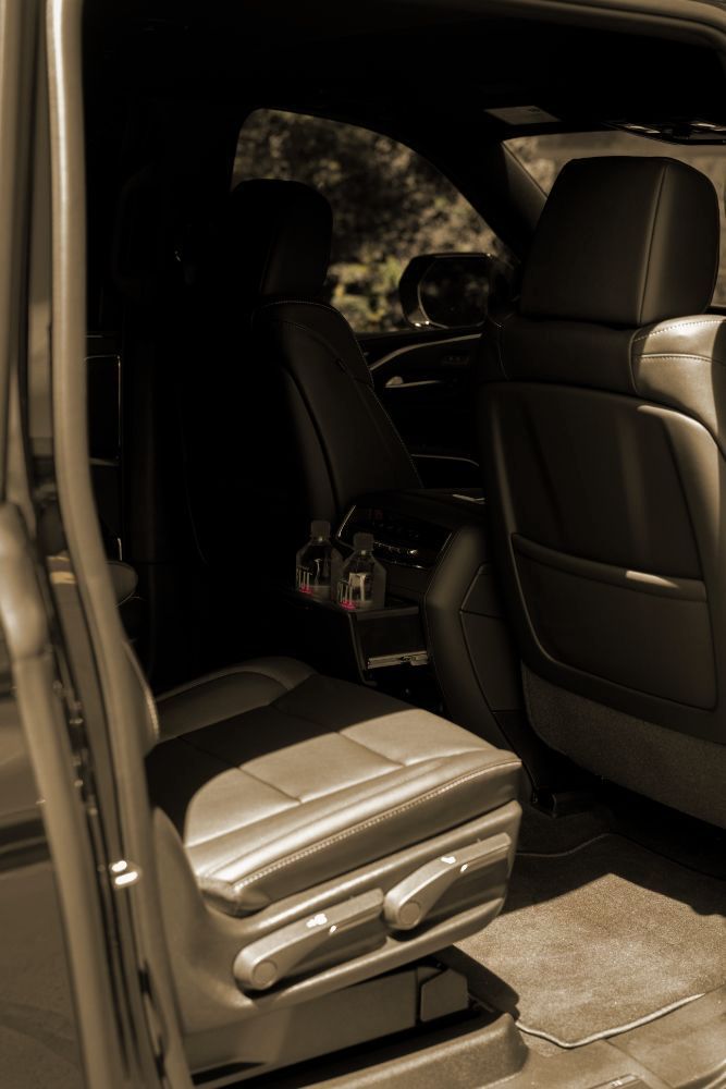A black and white photo of the back seat of a car.