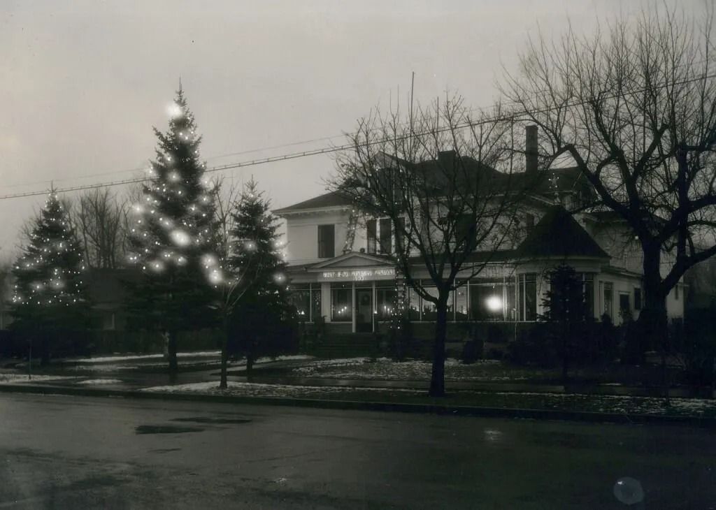 Snowy suburban house with a Christmas tree