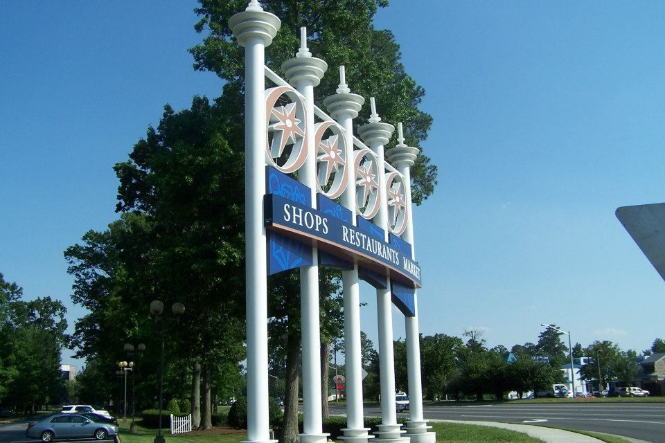 A blue and white sign that says shops on it