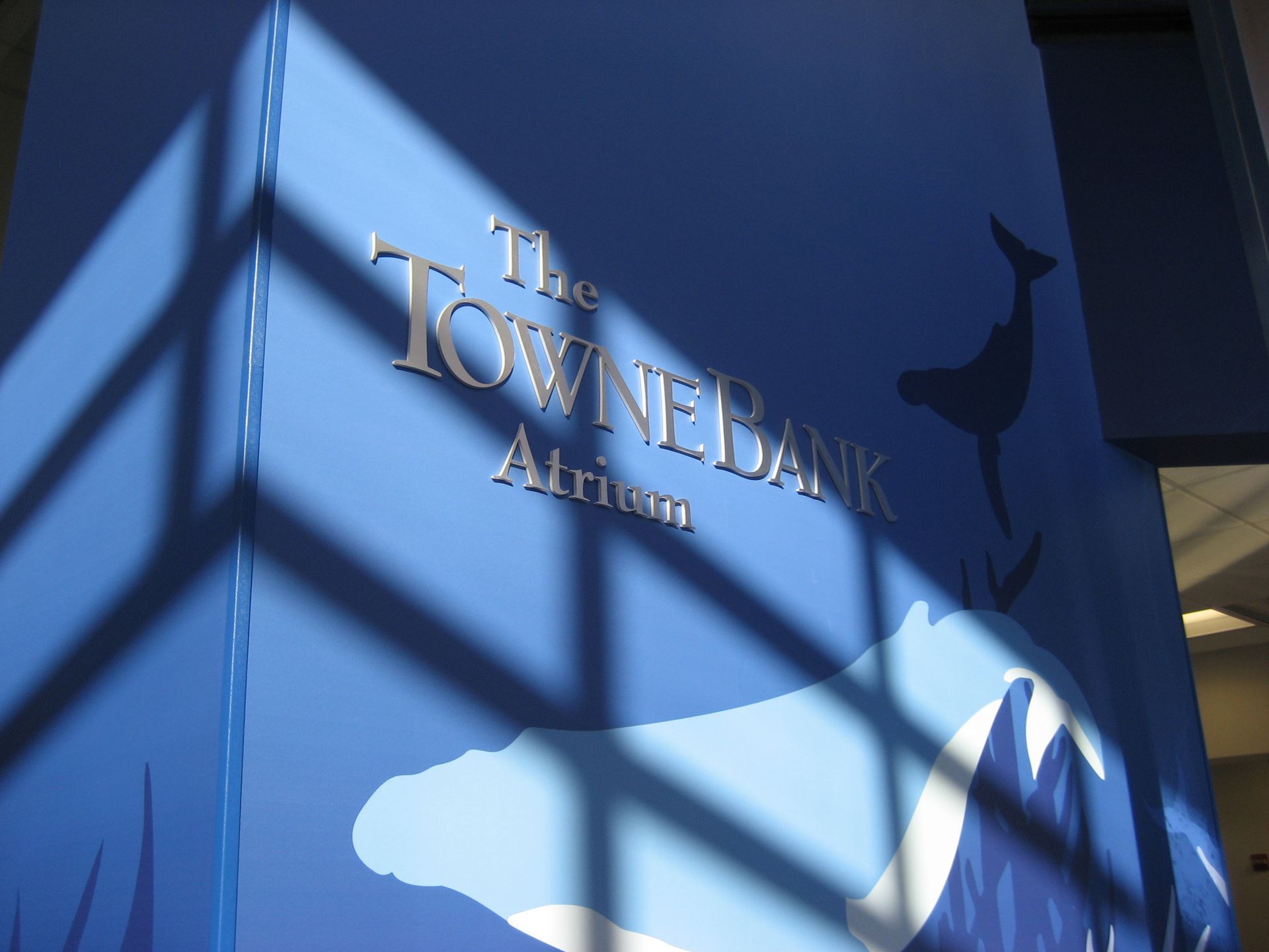 A sign that says the towne bank atrium on it