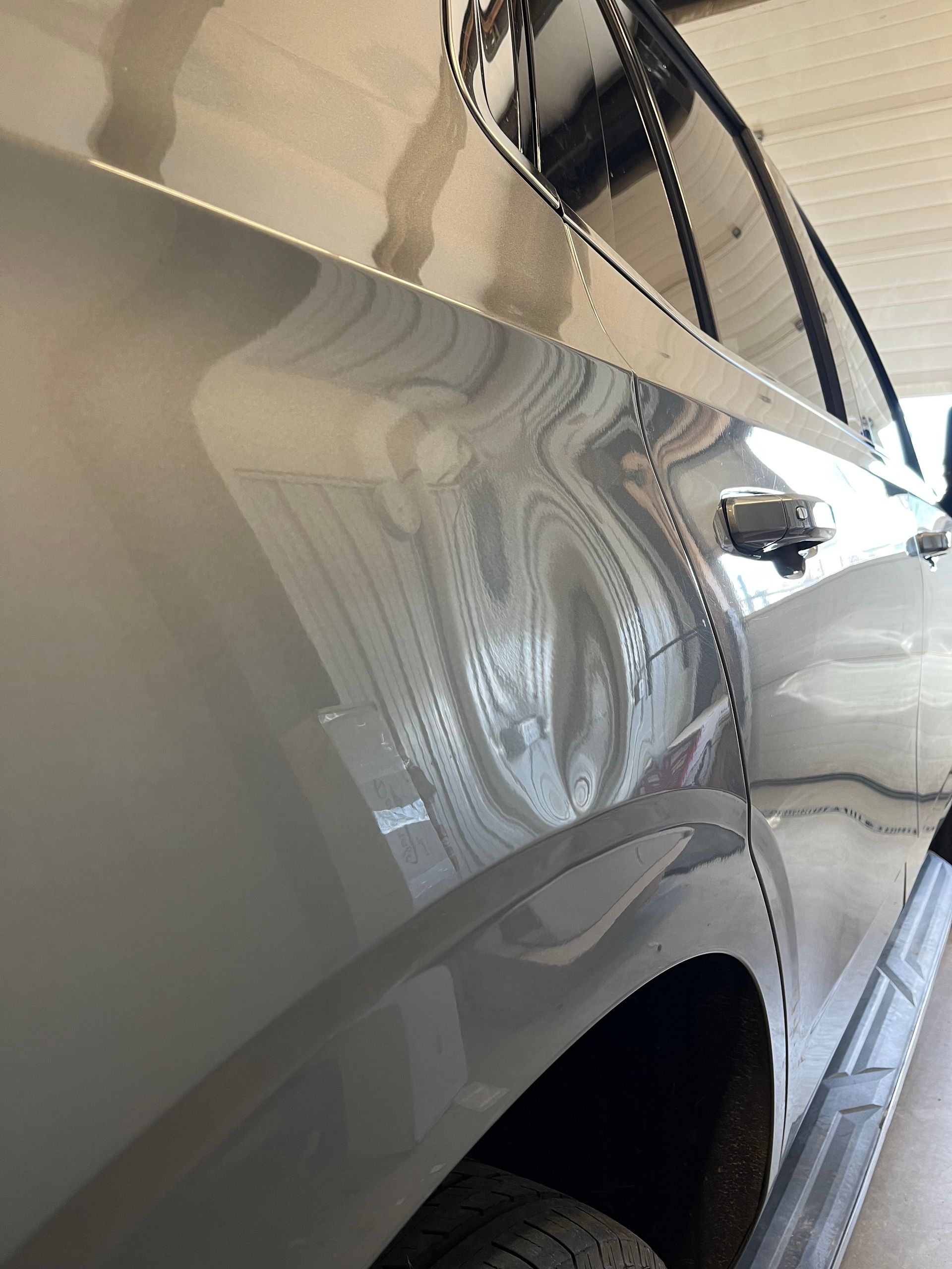 GMC Suburban quarter panel before Paintless Dent Repair