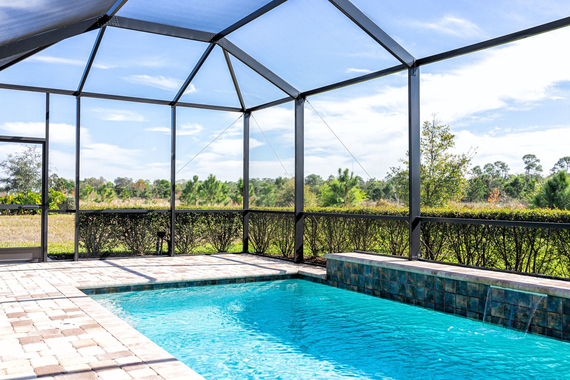 Screened pool enclosure with view of backyard landscape. Screened pool enclosure with view of backyard landscape.