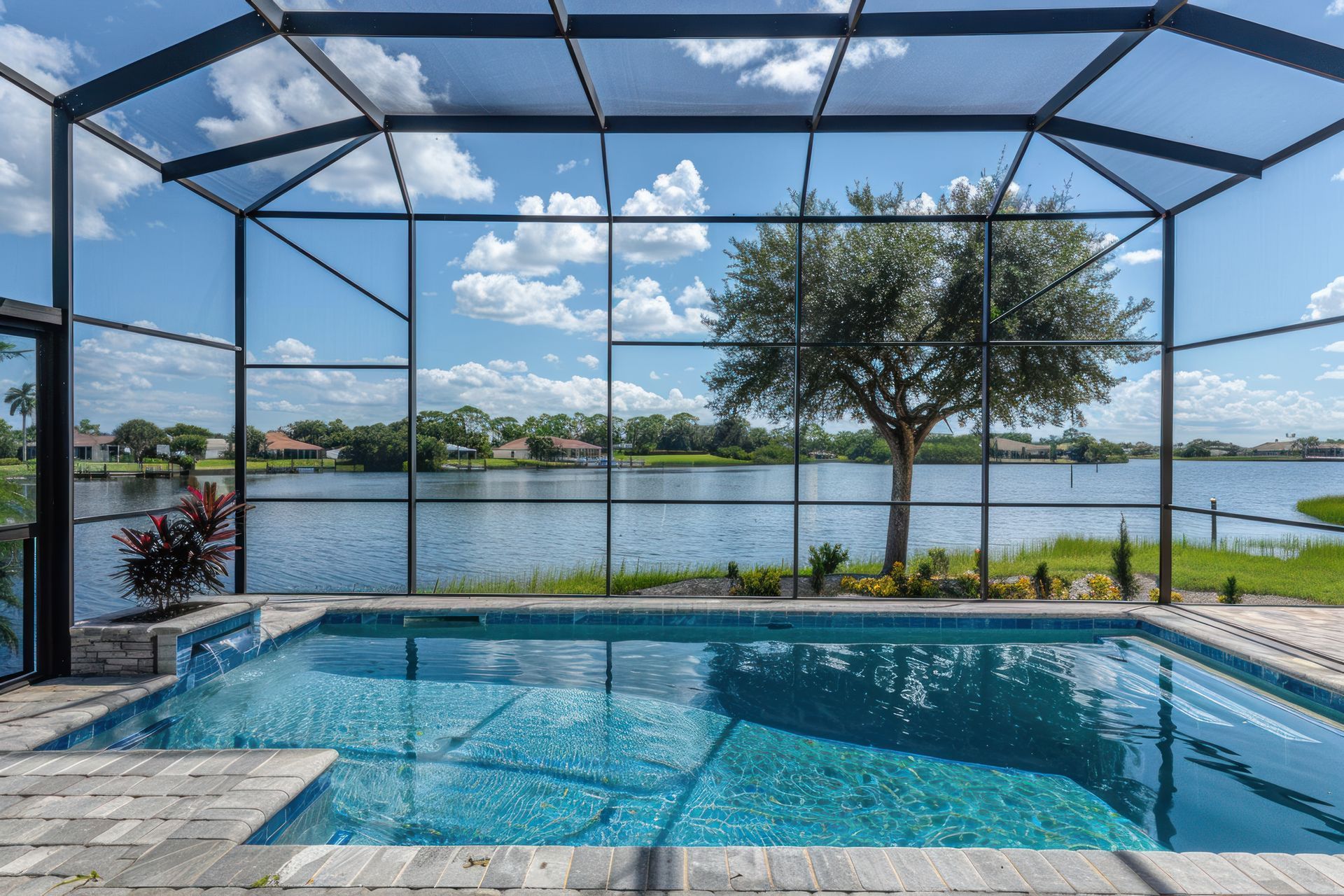 Lakefront pool enclosure by a professional pool enclosure contractor with custom screen cage design. Lakefront pool enclosure by a professional pool enclosure contractor with custom screen cage design.