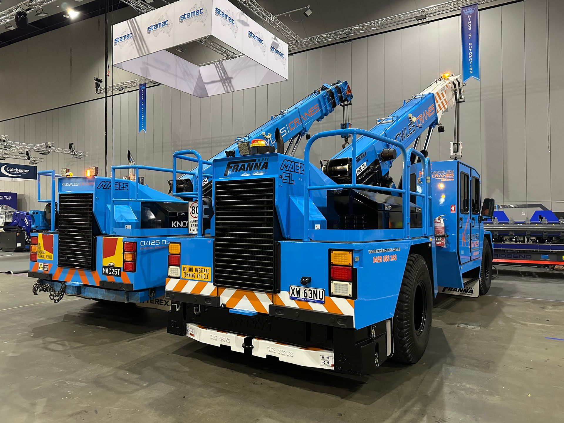 Franna cranes positioned indoors for equipment installation at exhibition site