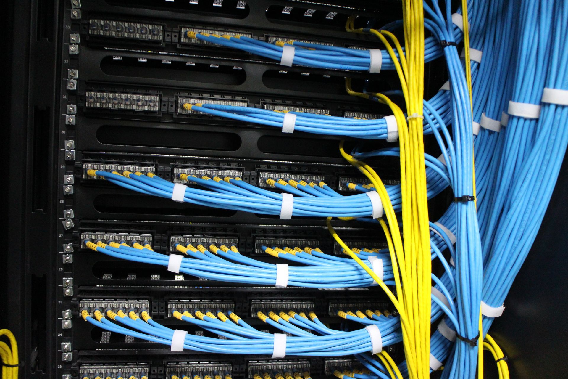 young it engeneer business man with thin modern aluminium laptop in network server room