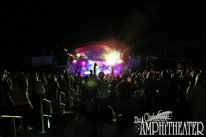 Night concert crowd facing a brightly lit stage at The Canadian Amphitheatre at night