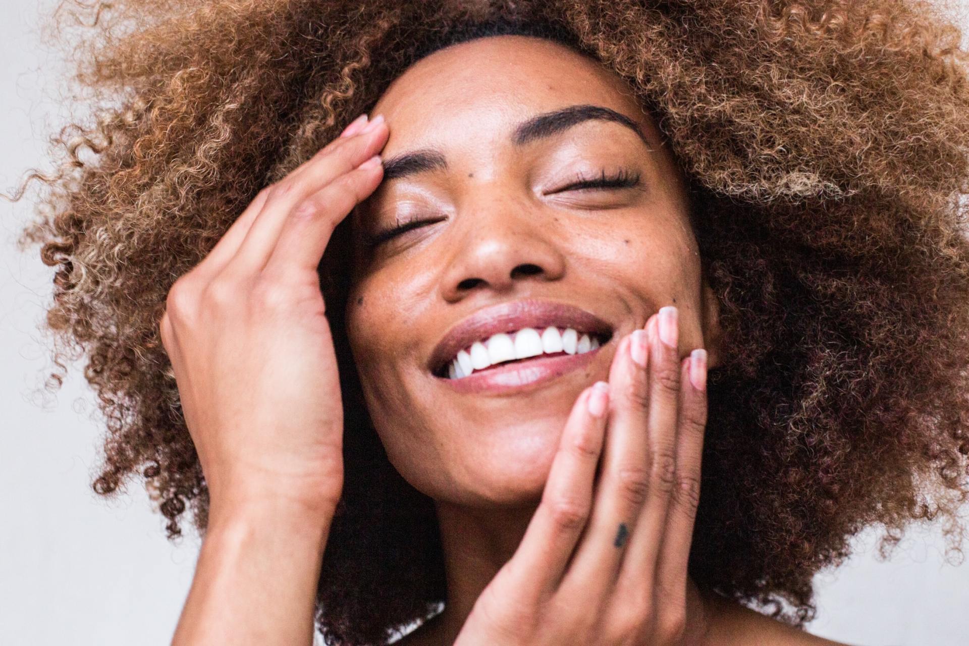 Smiling Woman Touching Face