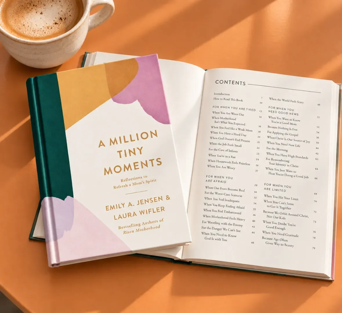 Open cookbook beside a coffee cup on an orange table, showing a chapter title and recipe list