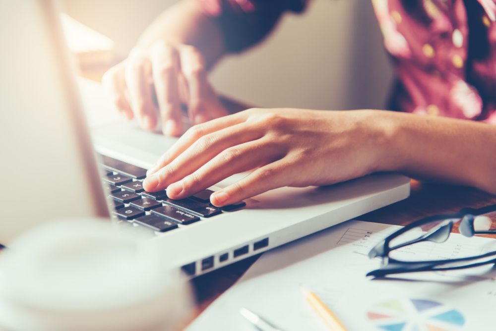 Hands Typing on a Laptop Keyboard — Precision Financial & Tax In Ross Creek, VIC