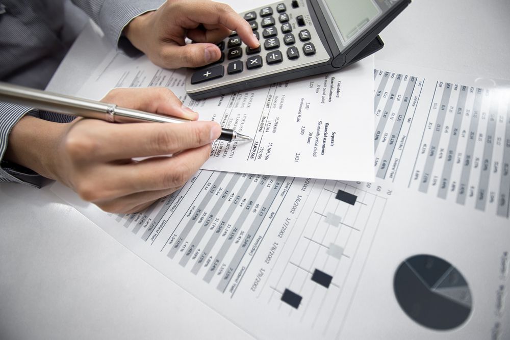 Person Using a Calculator and Pen — Precision Financial & Tax In Ross Creek, VIC