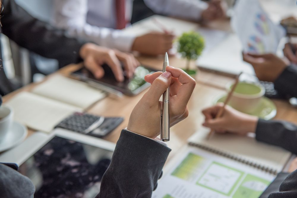 Business Meeting Around a Table, Taking Notes, and Reviewing Documents — Precision Financial & Tax In Ross Creek, VIC