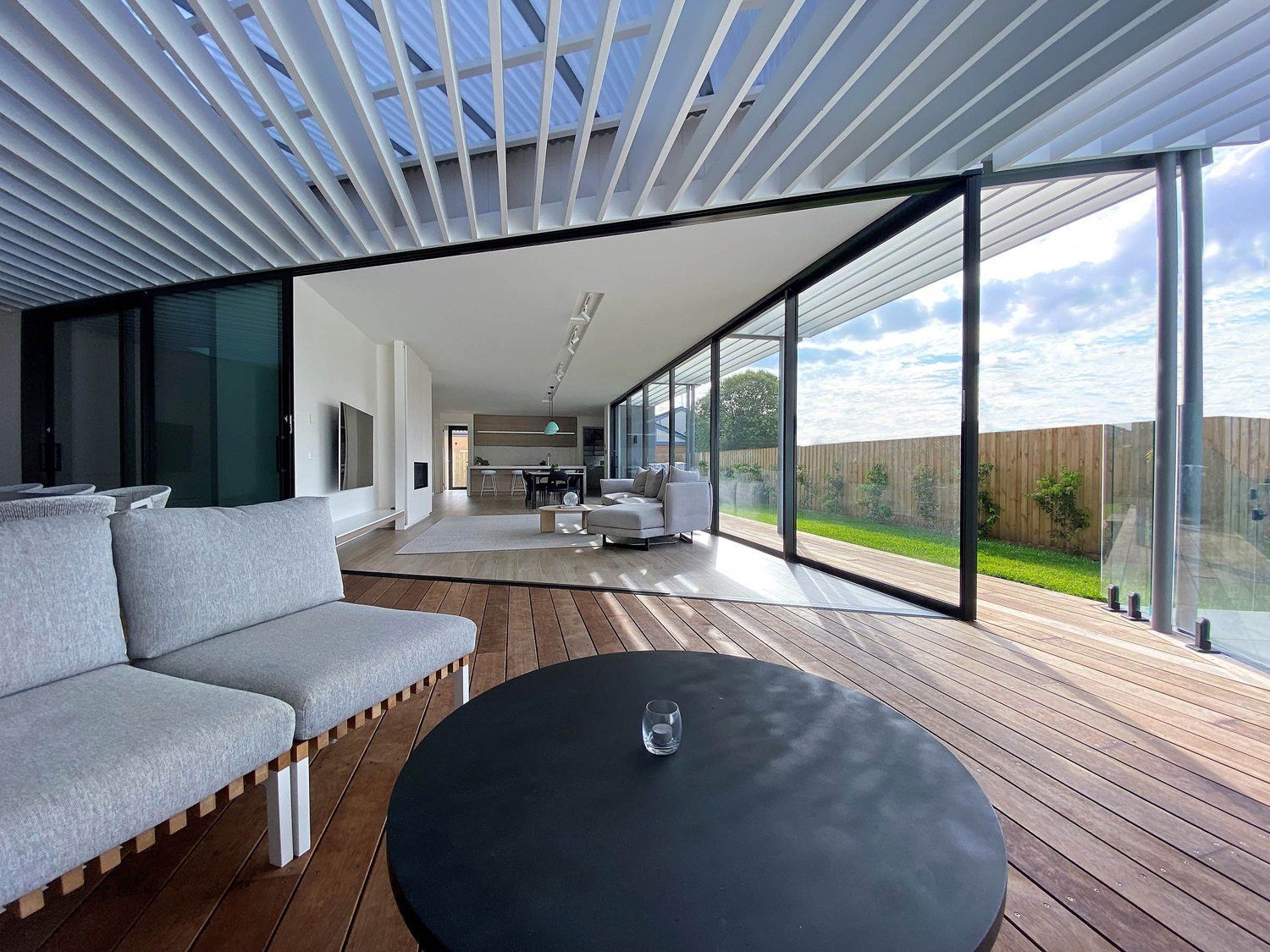 Modern Living Room With Sliding Glass Walls — KM Custom Homes In Mount Eliza, VIC