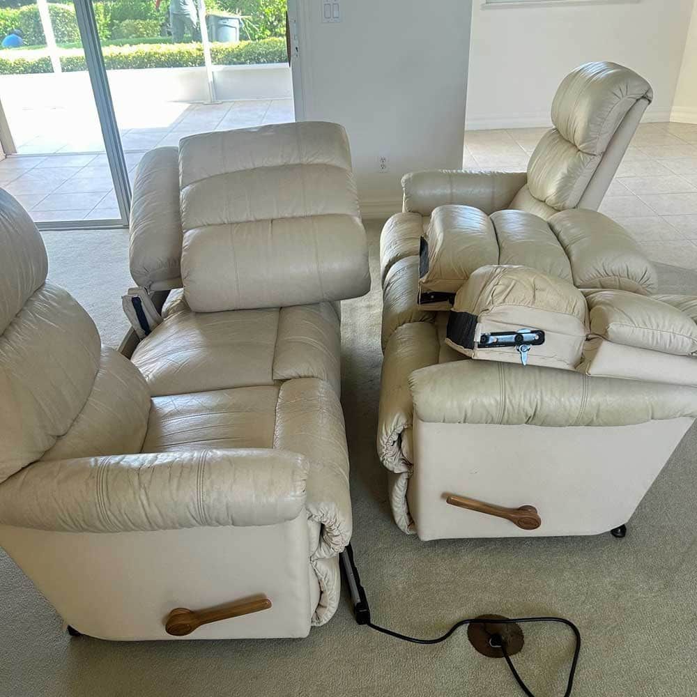 A living room with two recliner chairs and a couch.