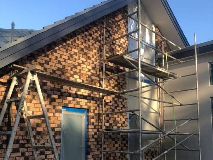 a brick building with scaffolding on the side of it