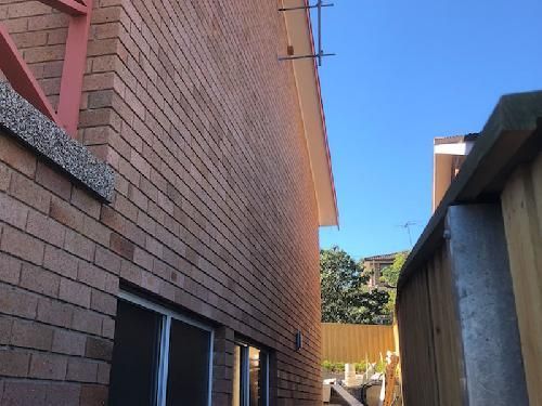 a brick building with a wooden fence in front of it .