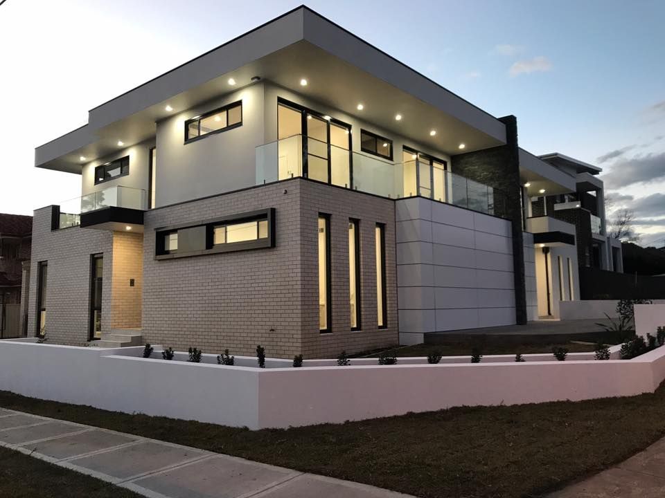 a large house with a lot of windows is lit up at night