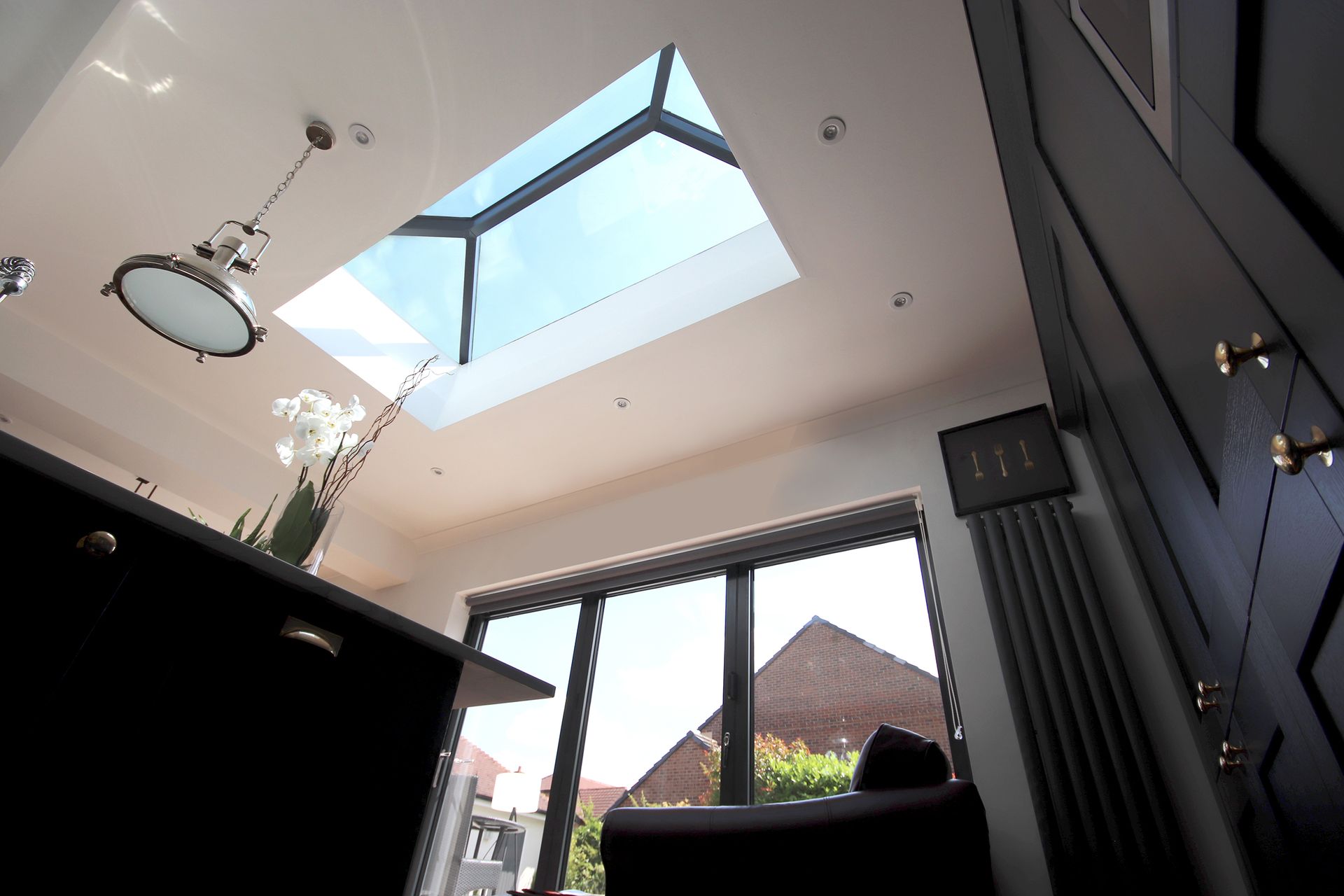 Kitchen interior with skylight and large window.
