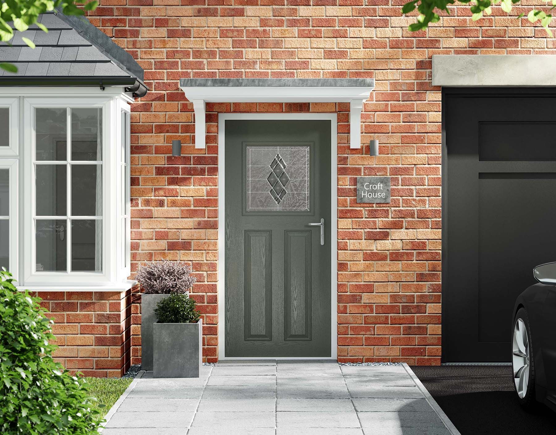 Green front door with a canopy and house number on brick wall, next to a garage.