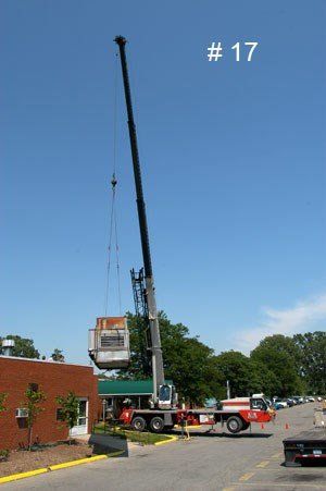 Front View of Lifting the Refrigerator — Detroit, MI — Astro Heating & Cooling Inc.