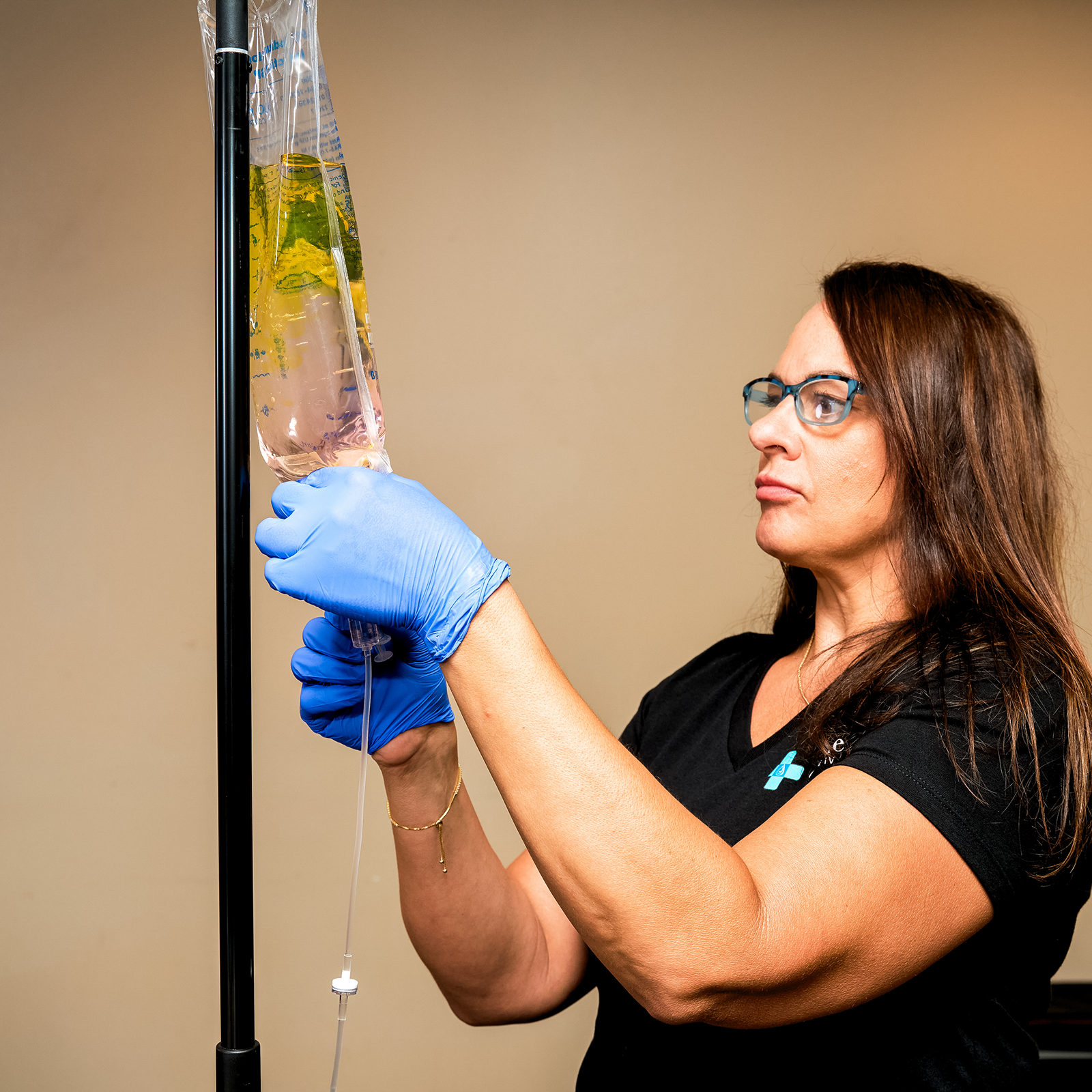 A woman is getting an injection in her arm in a hospital room.