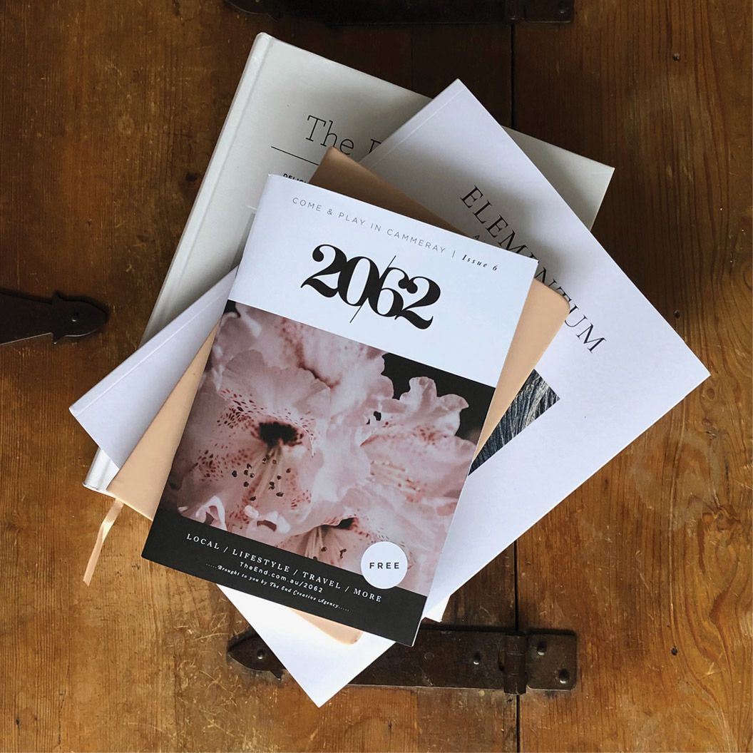 A stack of beautifully designed magazines with 2062 magazine on the top which was designed by magazine designers, The End Creative Agency in Sydney