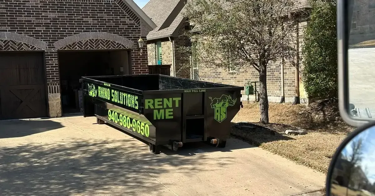 Rhino Solutions rental dumpster parked in driveway of Denton, TX home