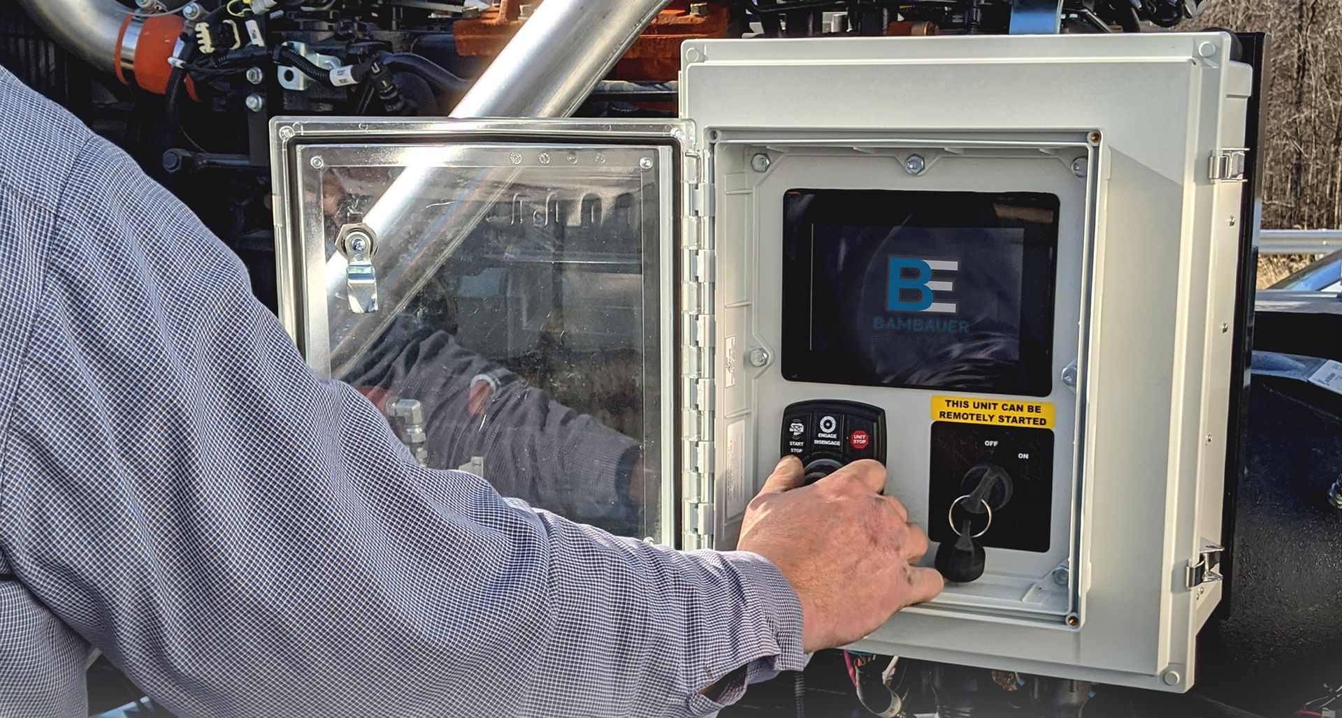Person pressing buttons on a control panel inside a metal enclosure